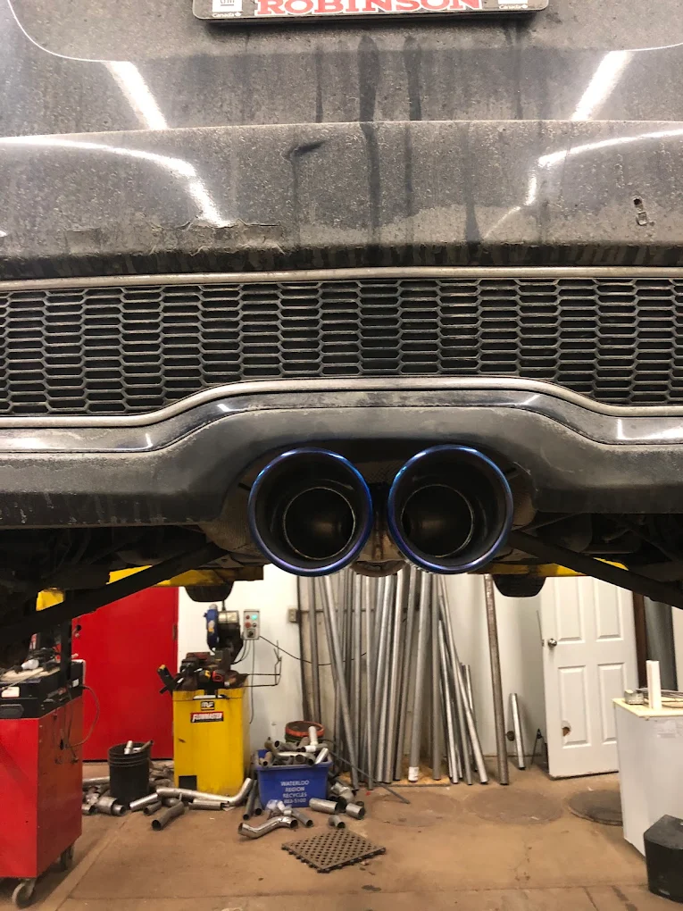 Racks of exhaust pipe stock and components held at Pete's Muffler